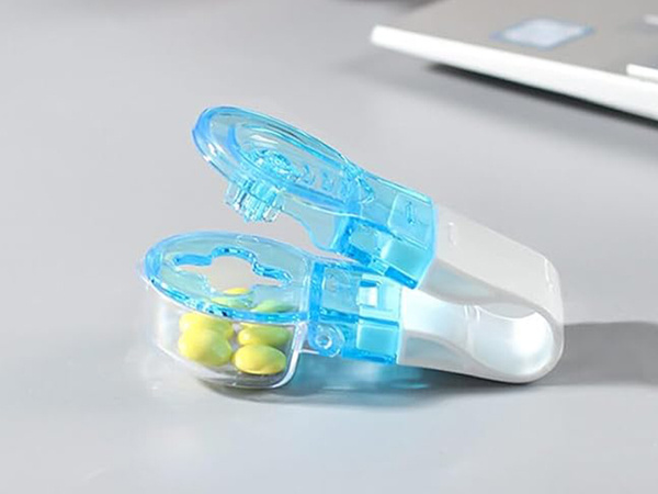 Pill remover for squeezing pills out of packs