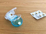 Pill remover for squeezing pills out of packs